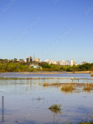 Uruguay river with high water levels and cityscape in the background - Uruguaiana, Brazil