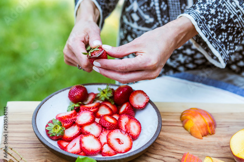 Woman slicing strawberries
