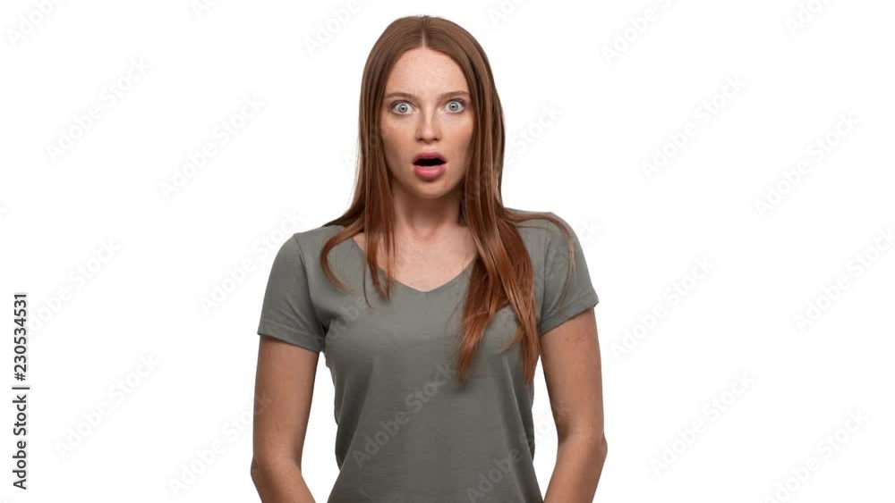 Portrait of displeased ginger woman 20s screaming in shock or outrage, isolated over white background slow motion. Concept of emotions Portrait of displeased ginger woman 20s screaming in shock or outrage, isolated over white background slow motion. Concept of emotions