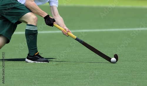 Field Hockey player, getting ready to pass the ball to a team mate.