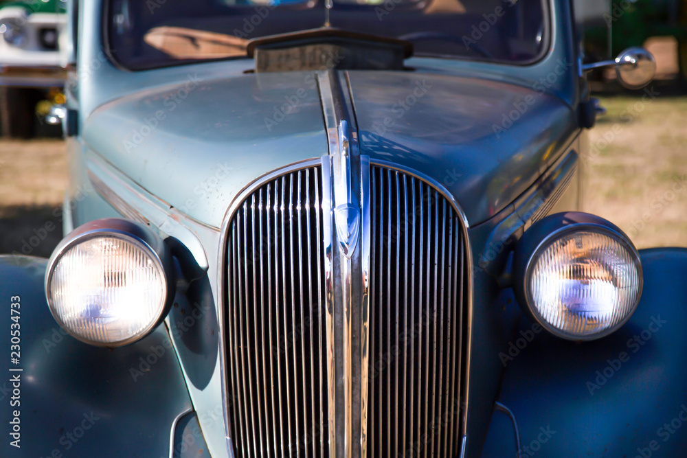 Partial close up perspective of antique car with out of focus background