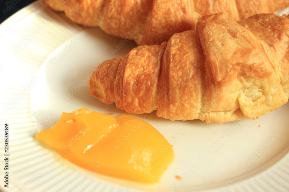 Fresh croissant and lemon curd