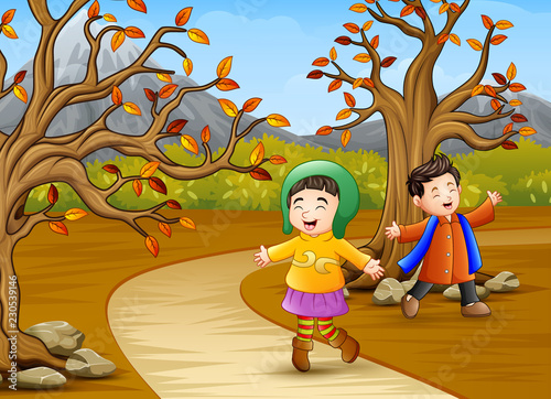 Happy kids playing in the autumn park