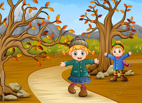 Happy kids playing in the autumn park