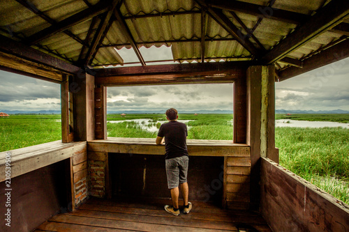 Male Tourist Background Near the window  temporary shelter on the way   you can see the surrounding nature  mountain fields and fresh air from the wind.