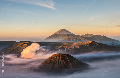Mount Bromo volcano (Gunung Bromo), and Batok during sunrise from viewpoint on Mount Penanjakan, in East Java, Indonesia. Early morning. photo