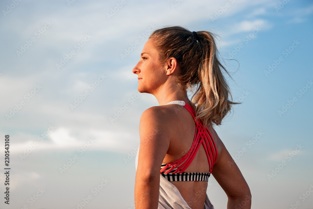 Athletic Female Runner Standing at Sunset Athletic Female Runner Standing at Sunset