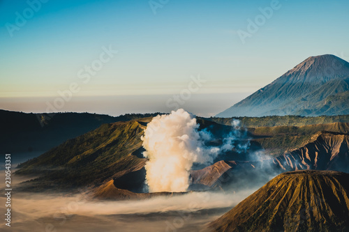 Mount Bromo volcano (Gunung Bromo), and Batok during sunrise from viewpoint on Mount Penanjakan, in East Java, Indonesia. Early morning.