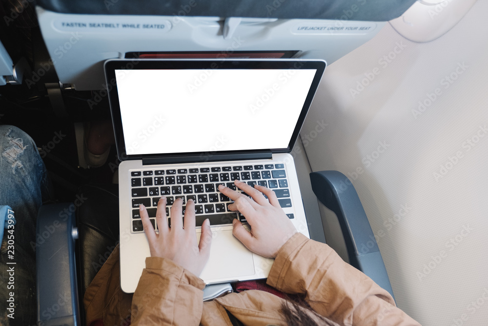 Fototapeta premium close-up hand typing keyboard computer in airplane