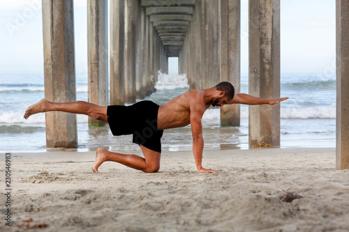 Male Yoga Instructor in Bird Dog Pose