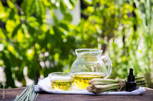 Lemongrass essential oil is placed on the table using a hand-drip oil lemongrass oil - spa and insect repellent. photo