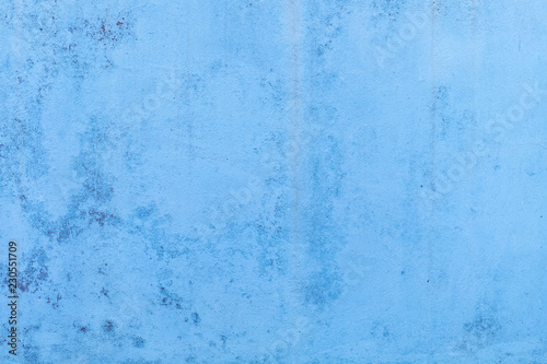 Blue concrete wall with water marks running down