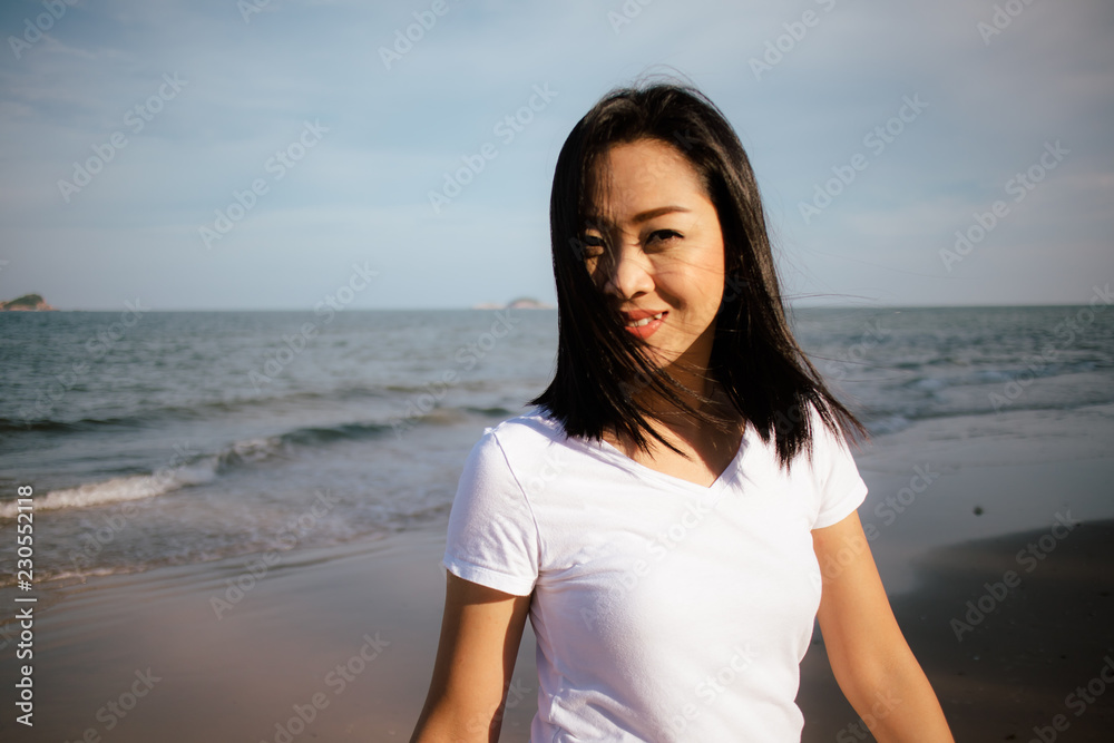 Happy woman enjoy the sunset light on the beach. Happy woman enjoy the sunset light on the beach.