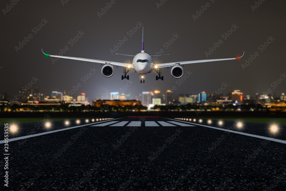 Airplane take off / landing at night with blurred town on background Stock  Photo | Adobe Stock