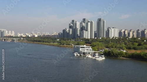 View on Banpo bridge, South part of Seoul, Han river Park, and 2 people riding jetboards photo