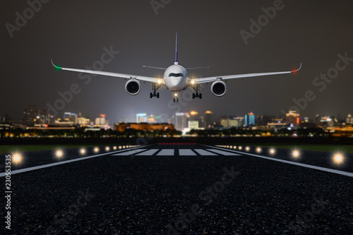 Airplane take off / landing at night with blurred town on background