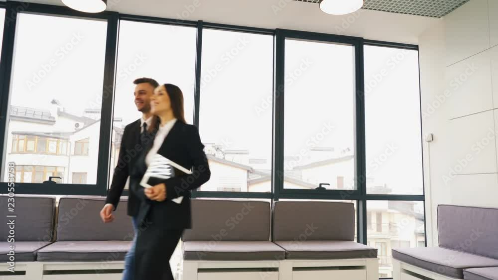 4K. Office meeting. Two business partner, man and woman, shake hands and go away 4K. Office meeting. Two business partner, man and woman, shake hands and go away