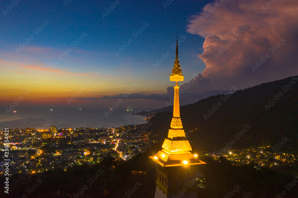 aerial view light on the crown of Phra That Phanom of Thepnimit temple on the top of Patong mountain in Phuket island Thailand..