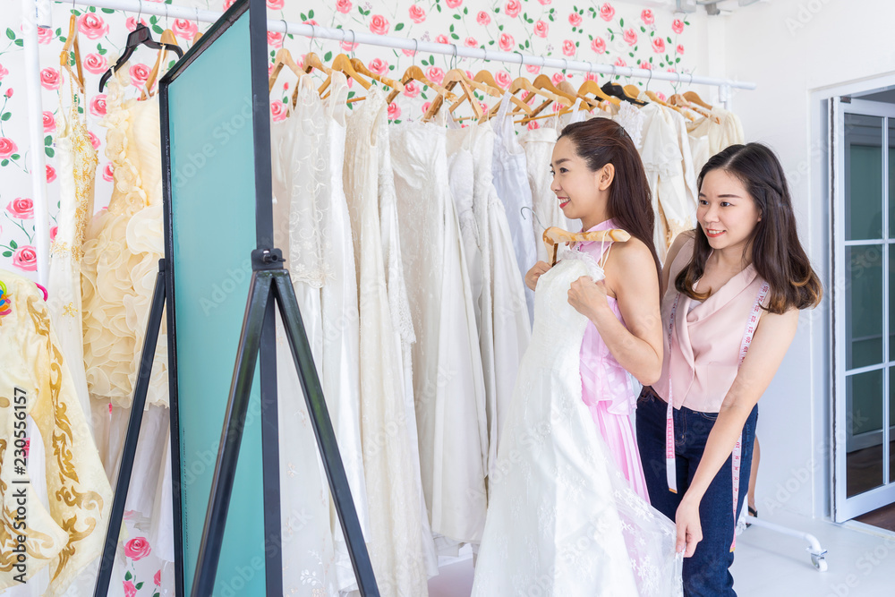beautiful Asian woman or Bride choosing wedding dress with
