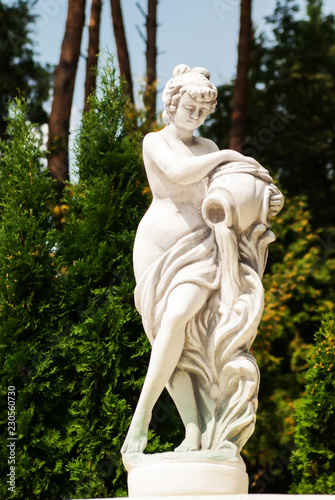 Girl with a jug. Statue.