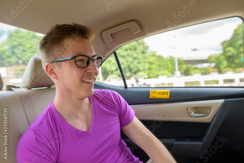 Young handsome tourist man traveling with taxi in Thailand © Ranta Images
