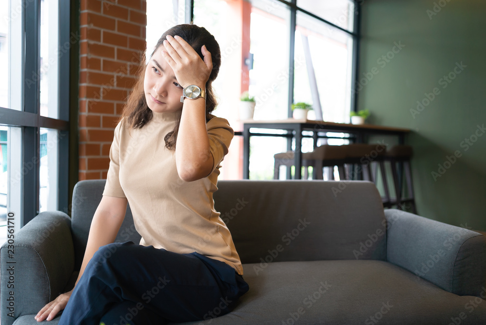 Asian woman headache and hand touch head in cafe background Asian woman headache and hand touch head in cafe background
