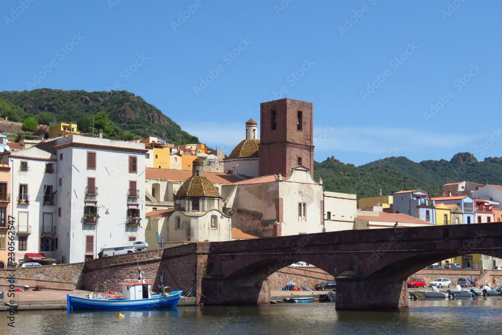 Picturesque view of church and bridge over the river in the historic town of Bosa, Sardinia, Italy