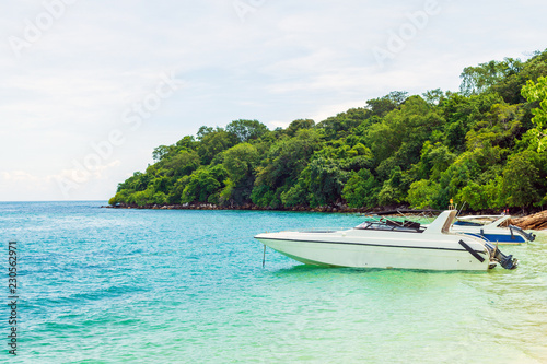 White motor boat docking on the beach with nature background. © tisomboon