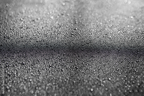 texture of water droplets on a glossy black surface