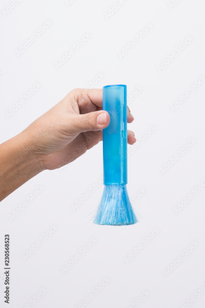 Hand with blue cleaning brush Hand with blue cleaning brush