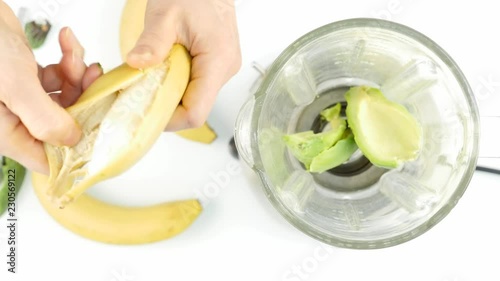 Woman prepares banana for smoothie, 4K photo