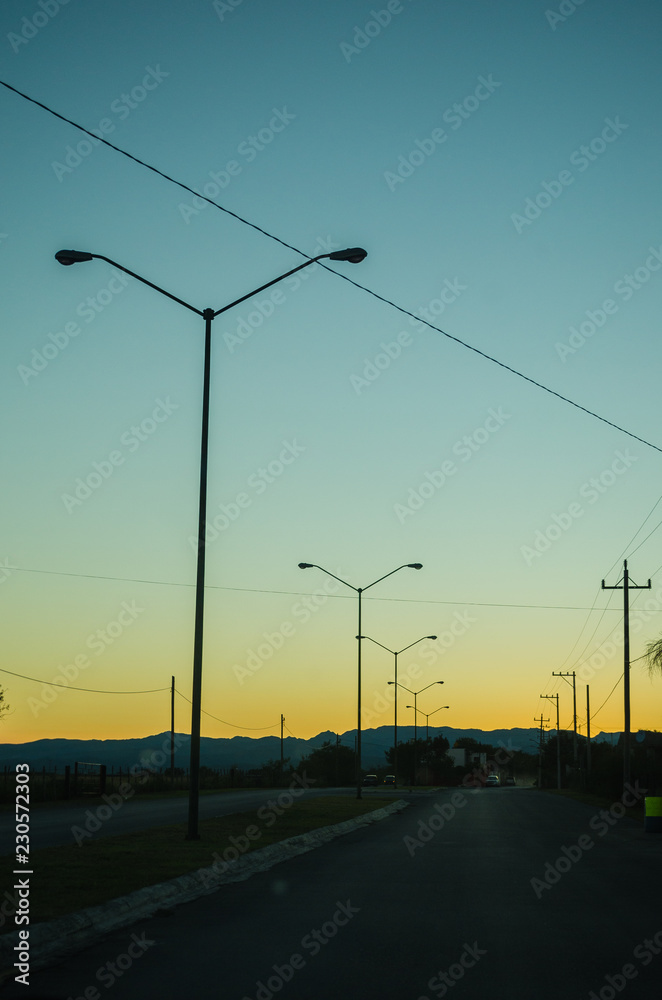 Road from the inside of a car and three light lamps