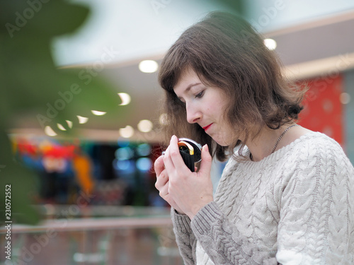 The girl looks in the pocket mirror