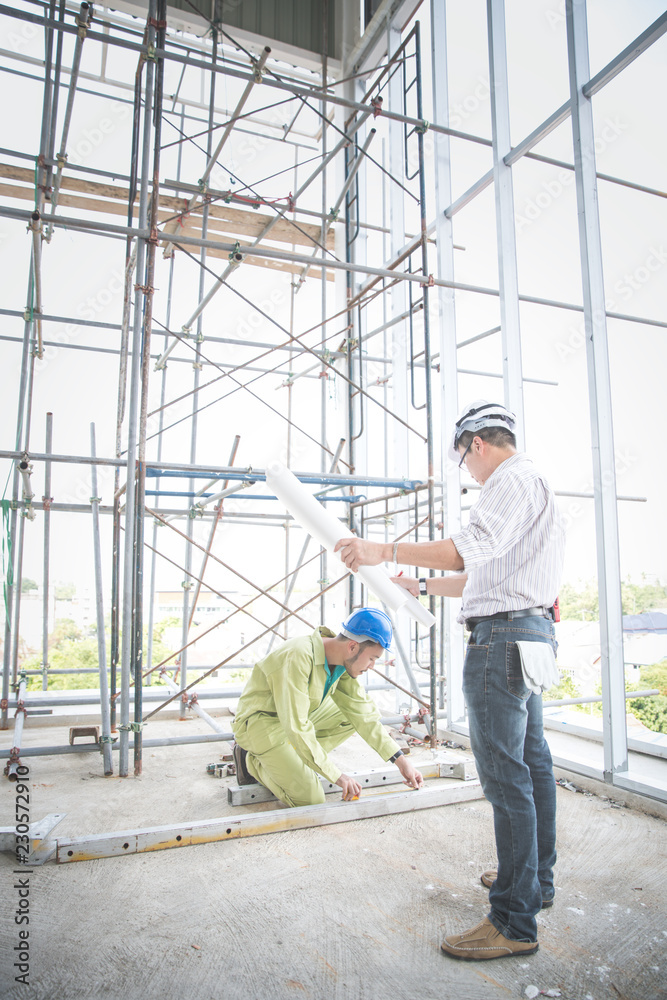 engineer people working and discussing with architecture or blueprint at construction site engineer people working and discussing with architecture or blueprint at construction site