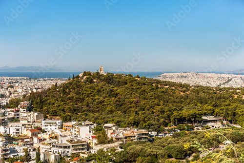 Athens city panorama with buildings standing close to each other and aegean see on horizon.