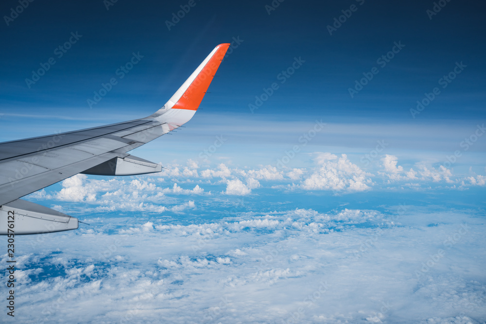 Fototapeta premium Beautiful view from airplane window and blue sky on nice sunny day, This time in altitude during flight.