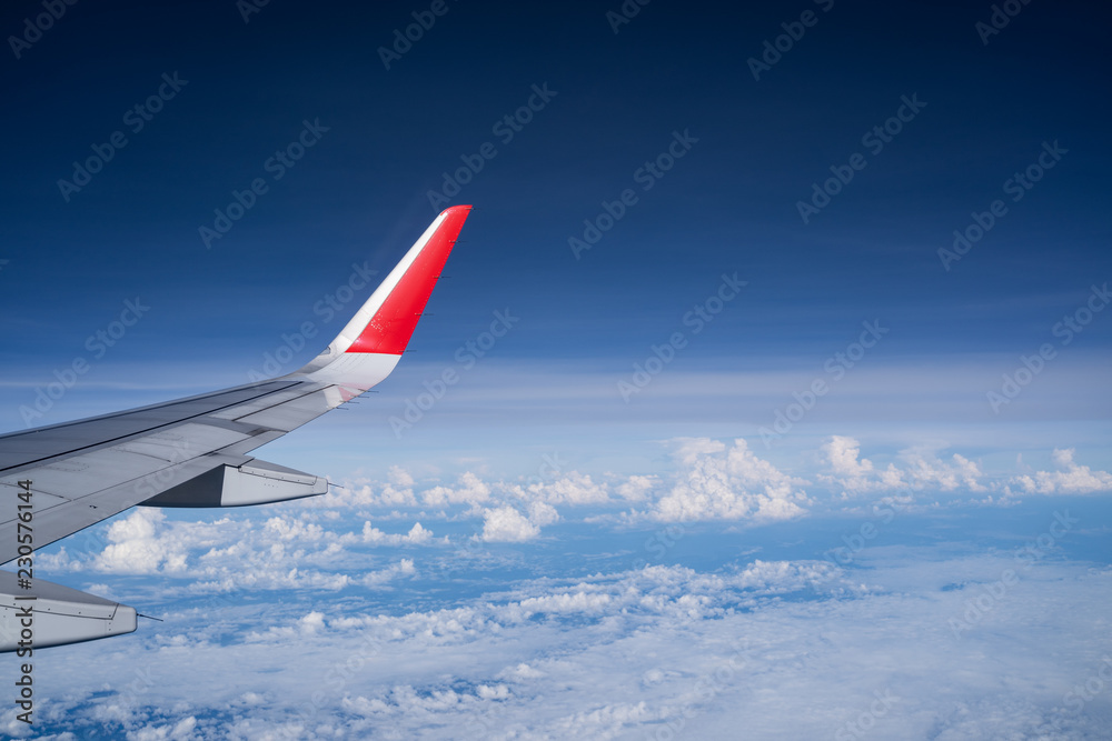 Fototapeta premium Beautiful view from airplane window and blue sky on nice sunny day, This time in altitude during flight.