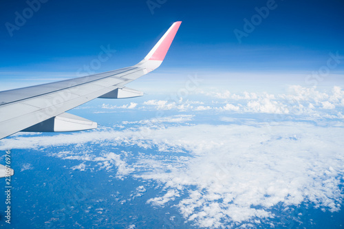 Beautiful view from airplane window and blue sky on nice sunny day, This time in altitude during flight.