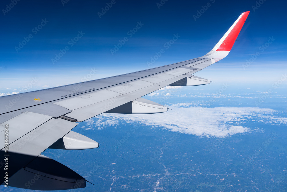 Fototapeta premium Beautiful view from airplane window and blue sky on nice sunny day, This time in altitude during flight.