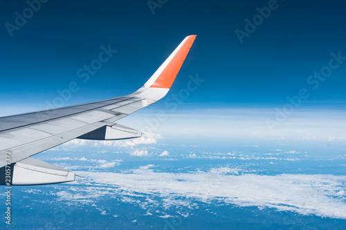 Beautiful view from airplane window and blue sky on nice sunny day, This time in altitude during flight.