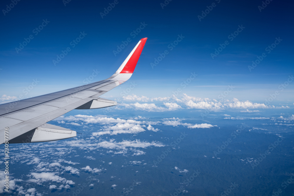 Beautiful view from airplane window and blue sky on nice sunny day, This time in altitude during flight.