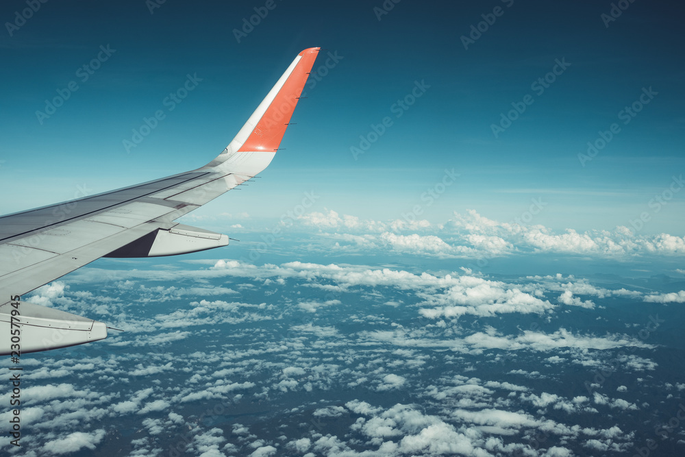 Fototapeta premium Beautiful view from airplane window and blue sky on nice sunny day, This time in altitude during flight.