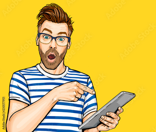 Amazed man in glasses with open mouth showing something on tablet. Emotions and advertisement. Surprised men.