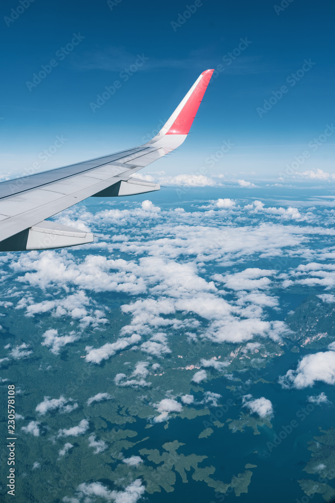 Fototapeta premium Beautiful view from airplane window and blue sky on nice sunny day, This time in altitude during flight.