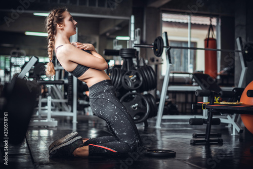 Cinematic tone of young attractive fitness woman exercise with machine in gym. Individual sport to fit muscles of body for healthy life concept. 