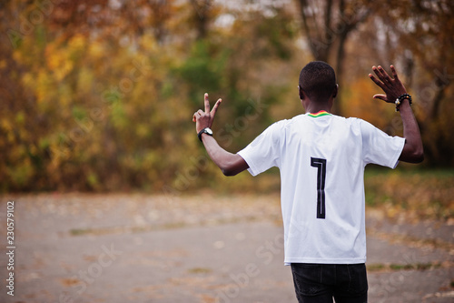 African man in white football sport t-shirt of Ghana Africa country with 7 number. photo