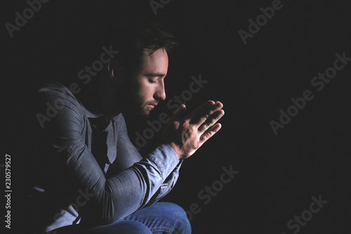 Religious young man praying...