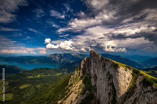 Panoramic view of mountains from Schafberg peak in Salzkammergut, Austria in a beautiful summer day with dramatic clouds and Attersee in the background