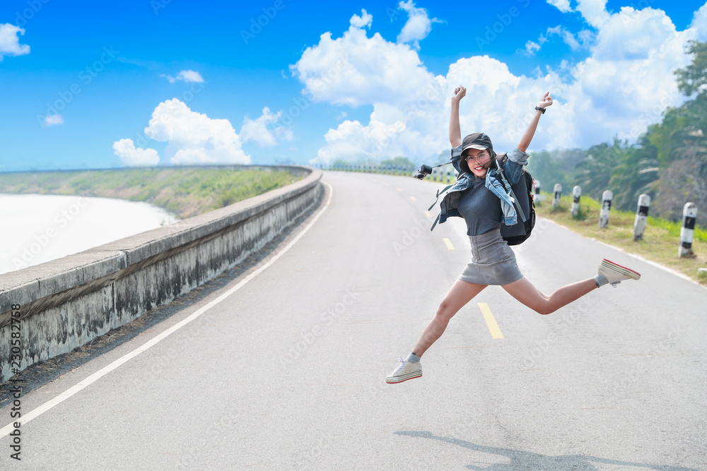 portrait of cheerful and beautiful woman jumping while traveling on holiday vacation portrait of cheerful and beautiful woman jumping while traveling on holiday vacation