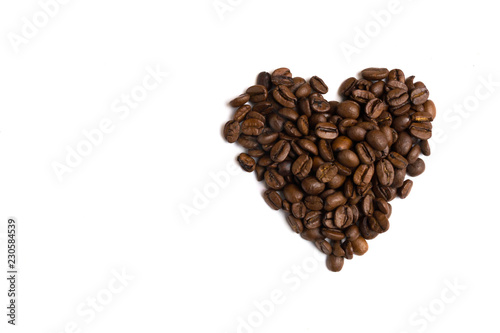 Heart made of coffee beans top view. Love coffee background isolated.